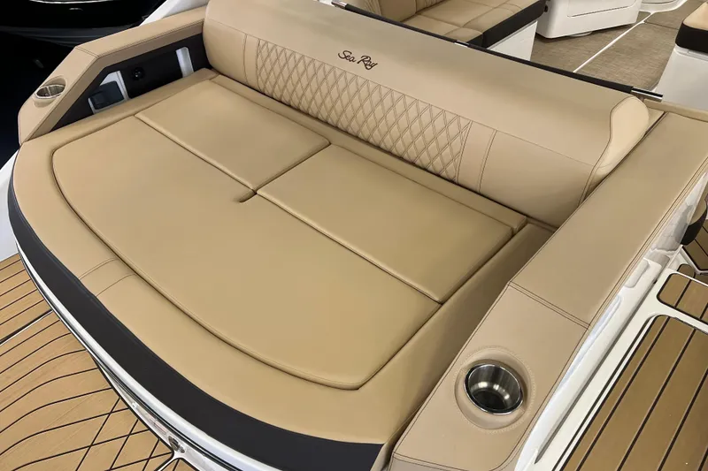 Slide: The Image of 2024 Sea Ray SLX 310 boat with luxurious tan seating and cup holders. - 6