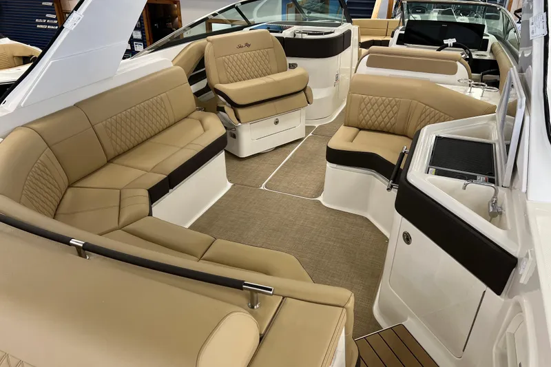 Slide: The Image of Luxurious interior of 2024 Sea Ray SLX 310 boat with tan seating and modern amenities. - 7