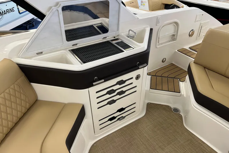 Slide: The Image of 2024 Sea Ray SLX 310 boat interior with beige seating and built-in grill. - 9