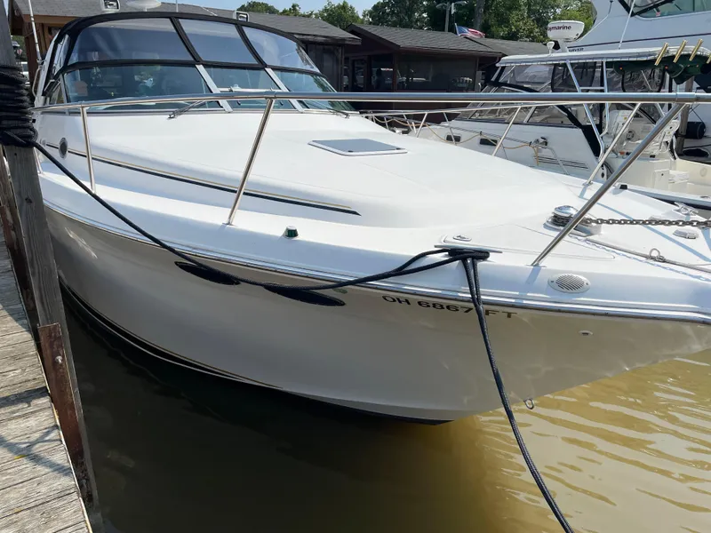 Slide: The Image of 1997 Sea Ray 330 Express docked at marina, white hull, sleek design. - 3