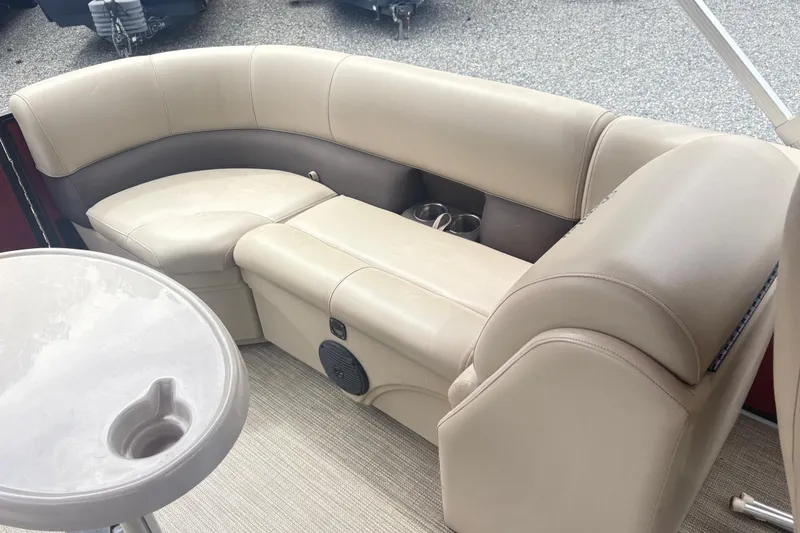 Slide: The Image of Luxurious seating on a 2022 Bentley Pontoons 220 Navigator with cup holders and table. - 10