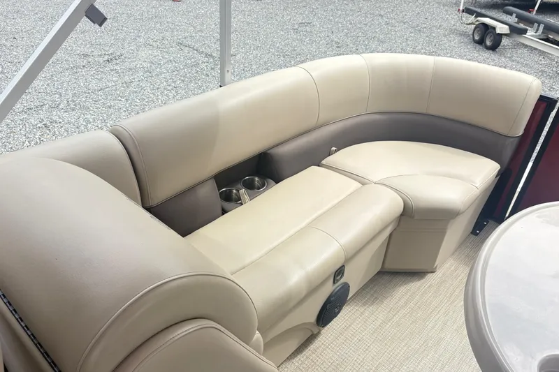 Slide: The Image of 2022 Bentley Pontoons 220 Navigator interior with beige seating and cup holders. - 11