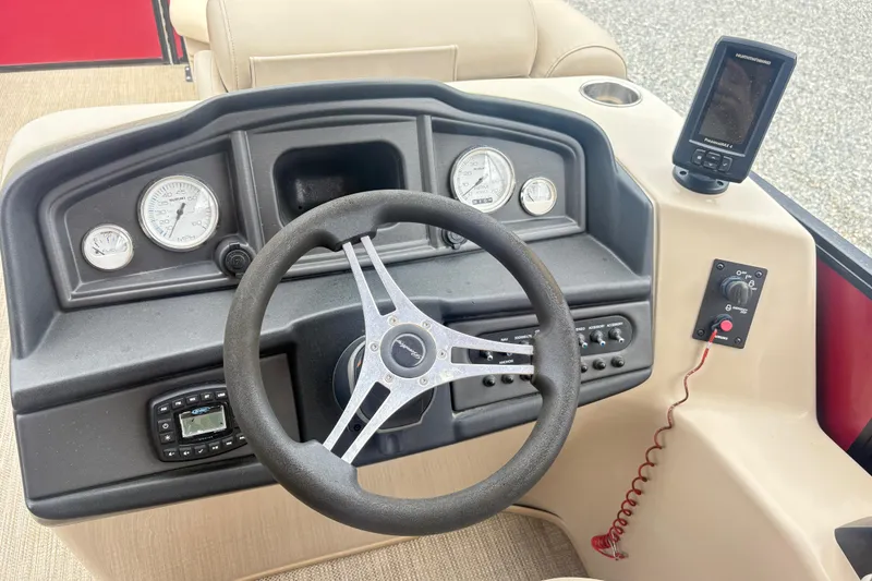 Slide: The Image of 2022 Bentley Pontoons 220 Navigator dashboard with steering wheel, gauges, and control panel. - 12