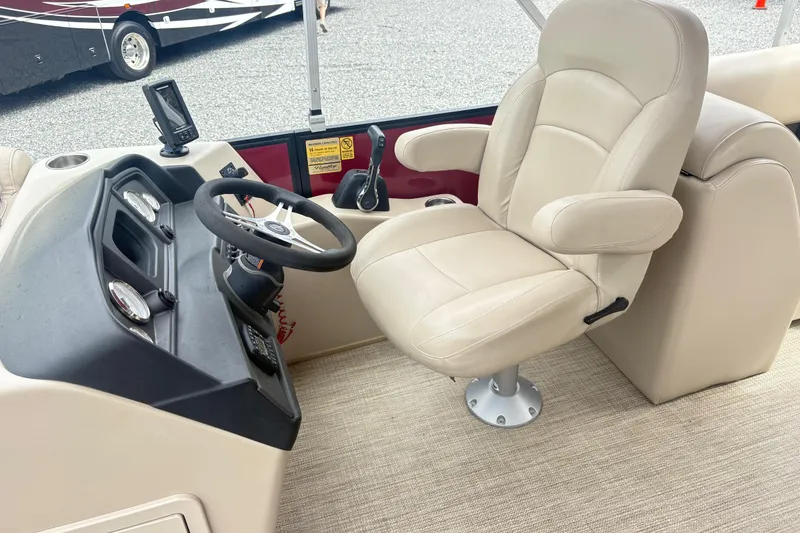 Slide: The Image of 2022 Bentley Pontoons 220 Navigator helm with beige captain's chair and control panel. - 13