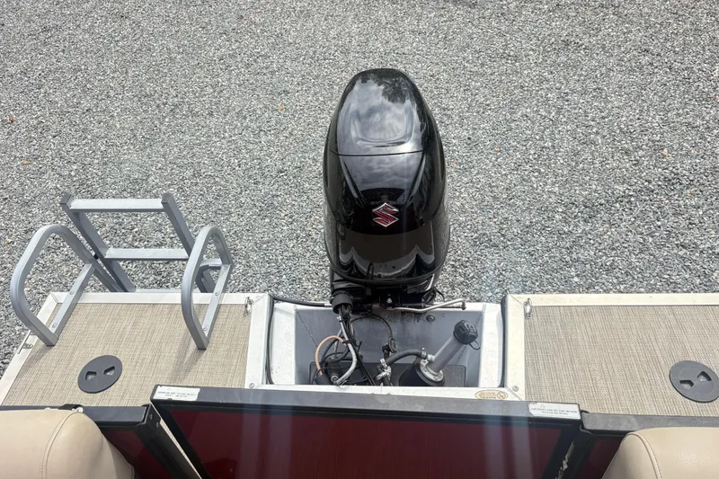 Slide: The Image of 2022 Bentley Pontoons 220 Navigator with Suzuki outboard motor on gravel surface. - 15