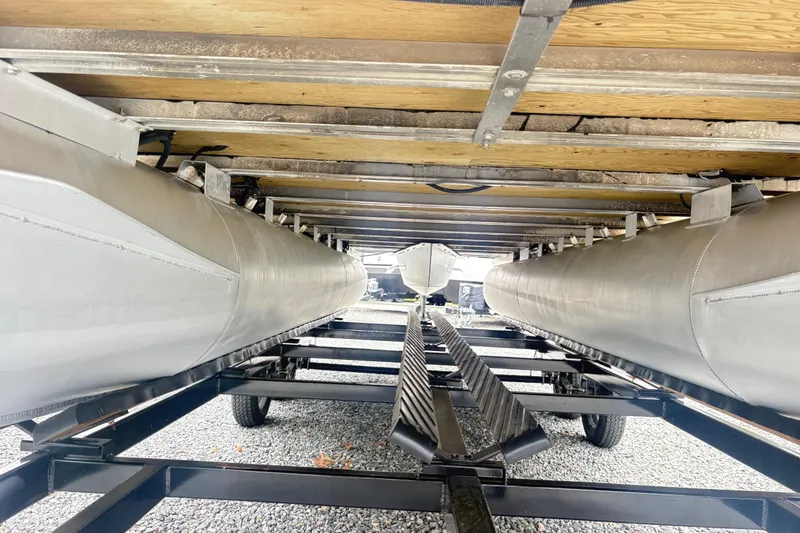 Slide: The Image of Underneath view of a 2022 Bentley Pontoons 220 Navigator on a trailer. - 2