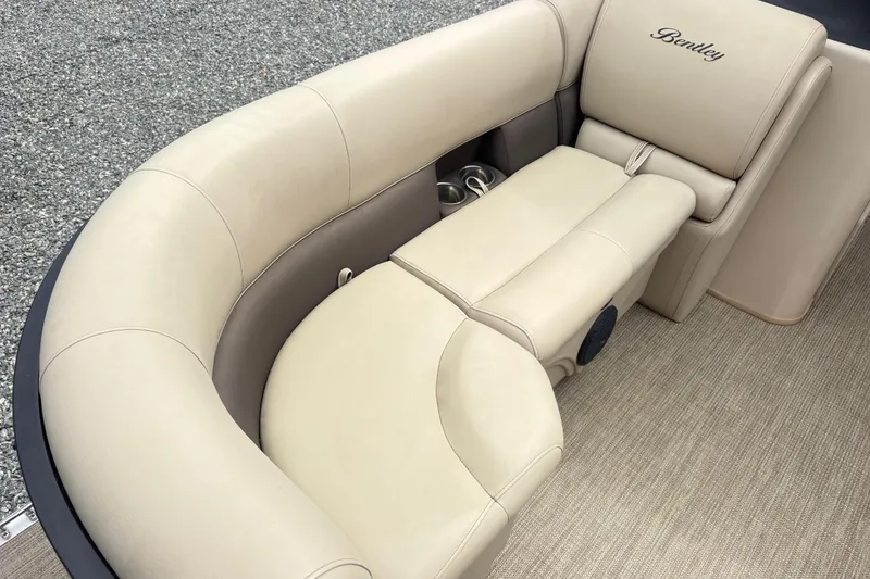 Slide: The Image of Luxurious seating on a 2022 Bentley Pontoons 220 Navigator boat, featuring beige upholstery. - 7