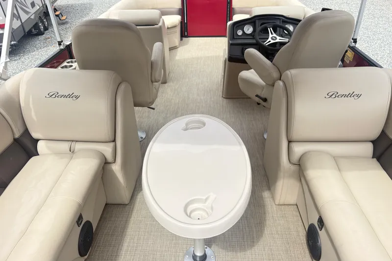Slide: The Image of Interior of 2022 Bentley Pontoons 220 Navigator with beige seating and steering console. - 9