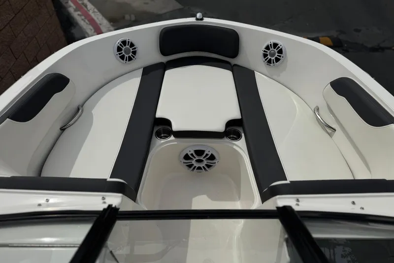 Slide: The Image of 2019 Bayliner VR6 Bowrider I/O boat interior with cushioned seating and speakers. - 11