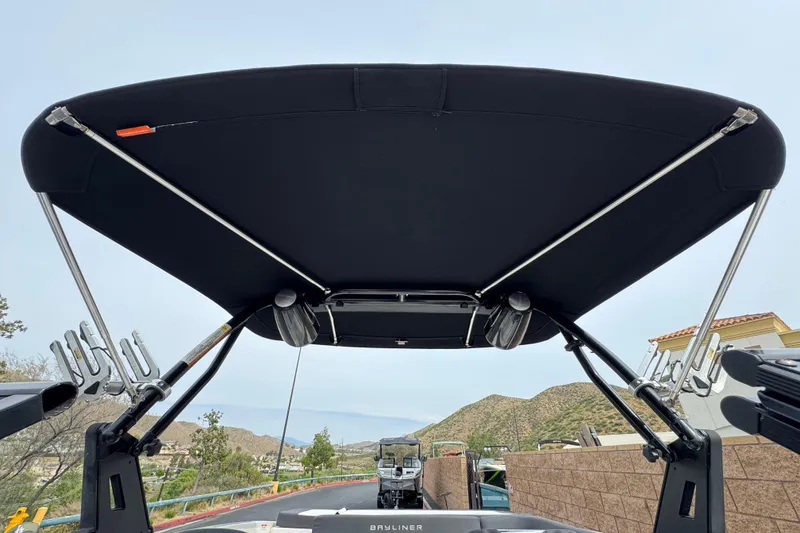Slide: The Image of 2019 Bayliner VR6 Bowrider I/O with black bimini top and wakeboard racks. - 15