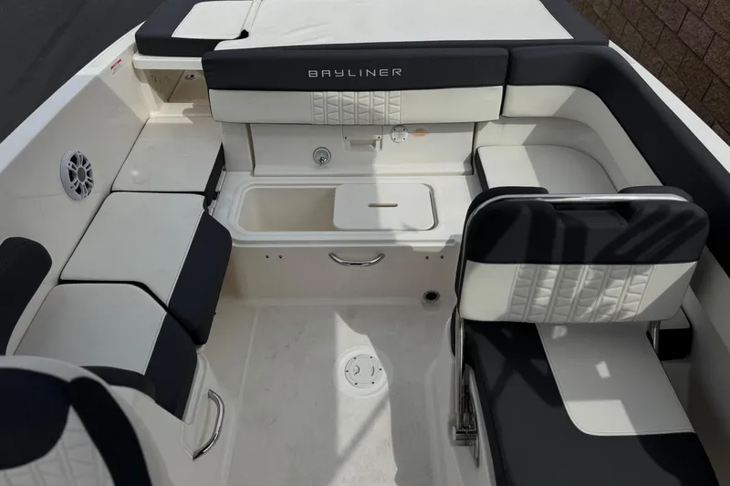 Slide: The Image of 2019 Bayliner VR6 Bowrider I/O interior with cushioned seating and storage compartments. - 18