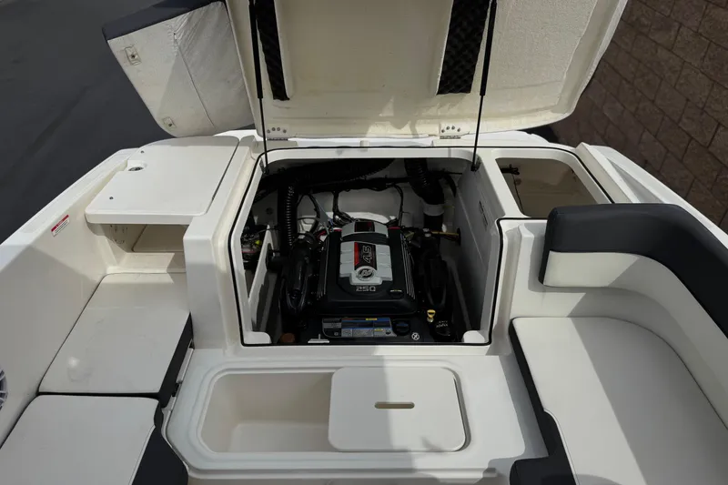 Slide: The Image of 2019 Bayliner VR6 Bowrider I/O engine compartment with open hatch, showcasing the engine. - 19
