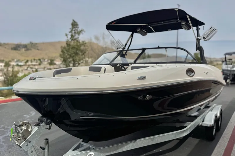 Slide: The Image of 2019 Bayliner VR6 Bowrider I/O on trailer, featuring sleek design and black hull. - 3