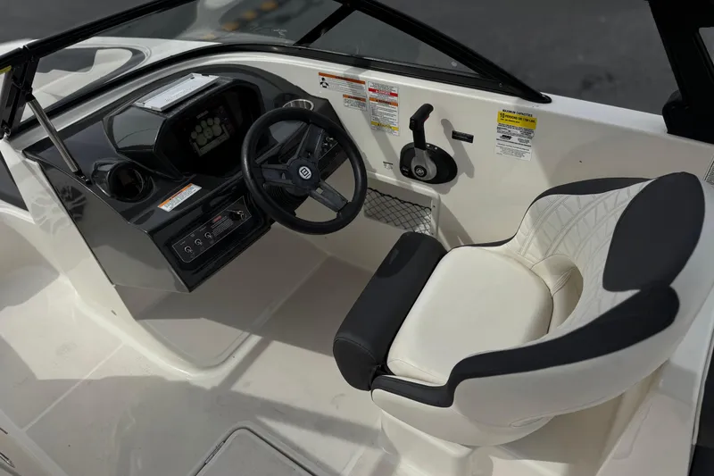 Slide: The Image of 2019 Bayliner VR6 Bowrider I/O cockpit with steering wheel and comfortable seating. - 32