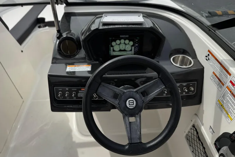 Slide: The Image of 2019 Bayliner VR6 Bowrider I/O dashboard with steering wheel and control panel. - 33