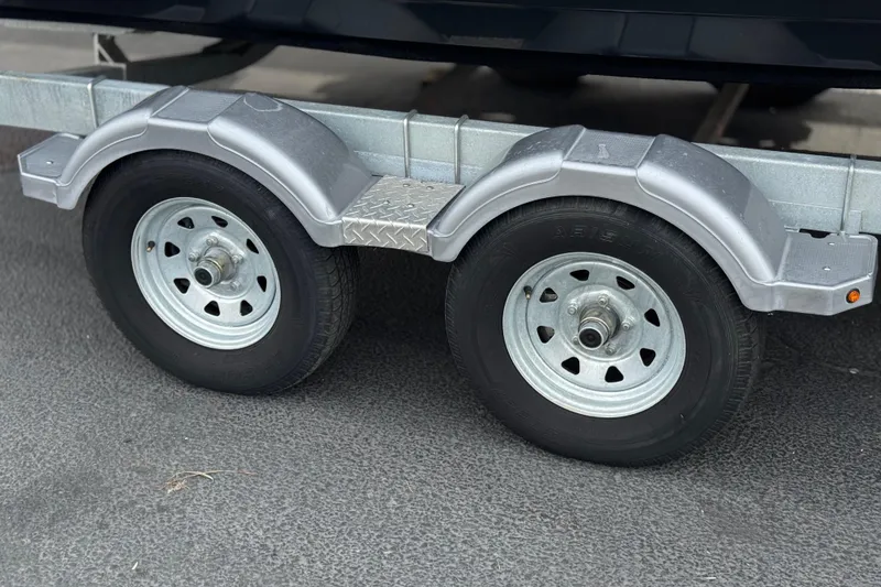 Slide: The Image of Trailer wheels for 2019 Bayliner VR6 Bowrider I/O on asphalt surface. - 38