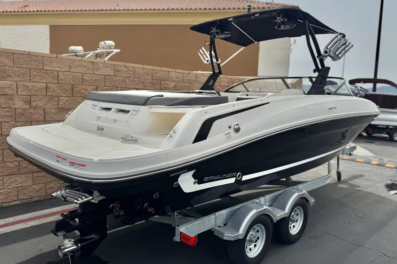 Slide: The Image of 2019 Bayliner VR6 Bowrider I/O on trailer, parked outdoors, showcasing sleek design. - 5