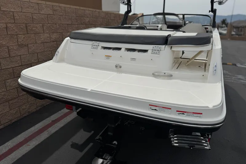Slide: The Image of 2019 Bayliner VR6 Bowrider I/O boat rear view with swim platform and ladder. - 6