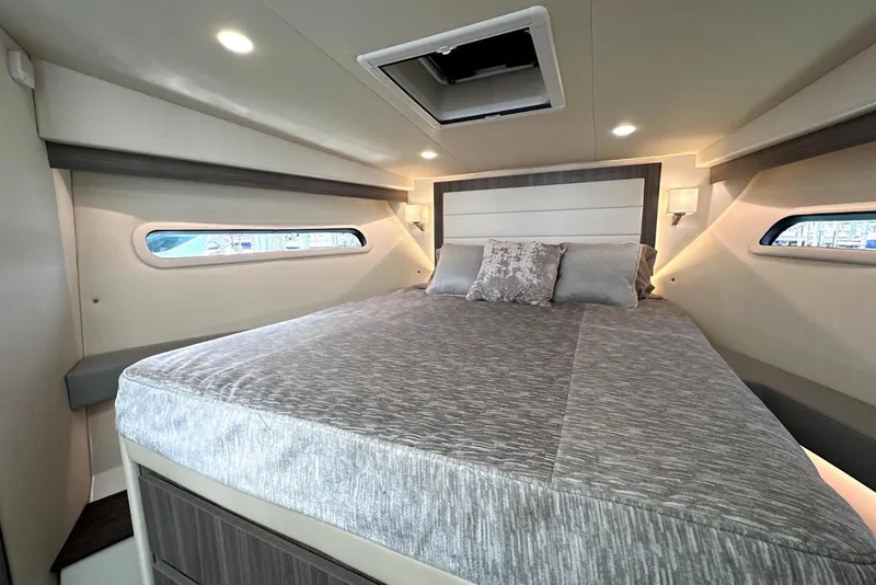 Slide: The Image of Luxurious bedroom interior of 2021 Regal 38 XO yacht with modern design and cozy bedding. - 10