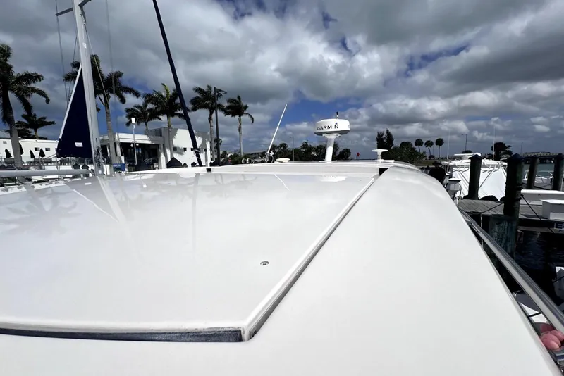 Slide: The Image of 2021 Regal 38 XO yacht docked at marina under cloudy sky. - 19