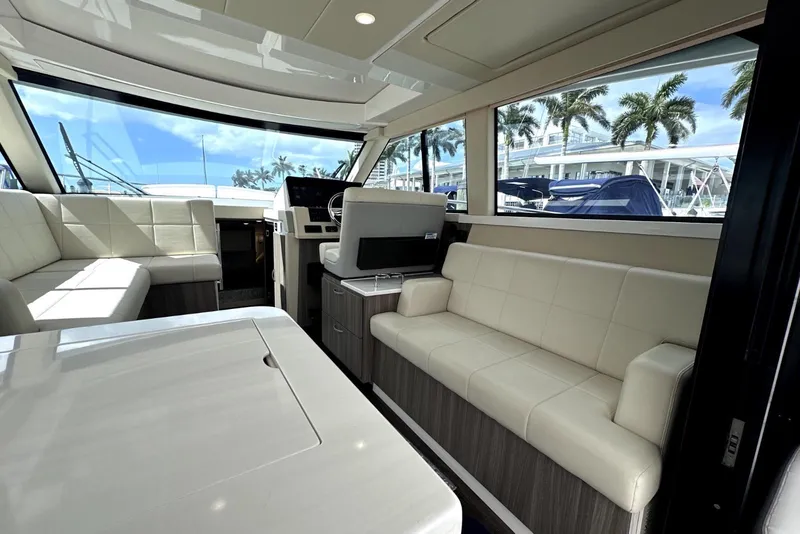 Slide: The Image of Luxurious interior of 2021 Regal 38 XO yacht with plush seating and panoramic windows. - 20