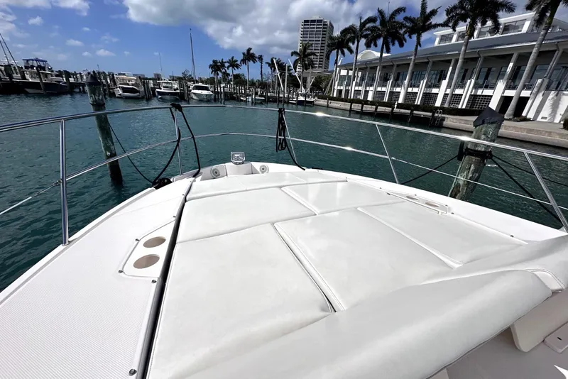 Slide: The Image of 2021 Regal 38 XO yacht docked at marina with palm trees and blue sky. - 21