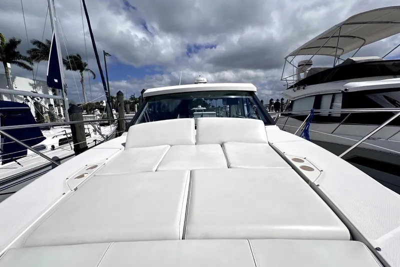 Slide: The Image of 2021 Regal 38 XO yacht with spacious sunbathing deck under cloudy sky. - 28