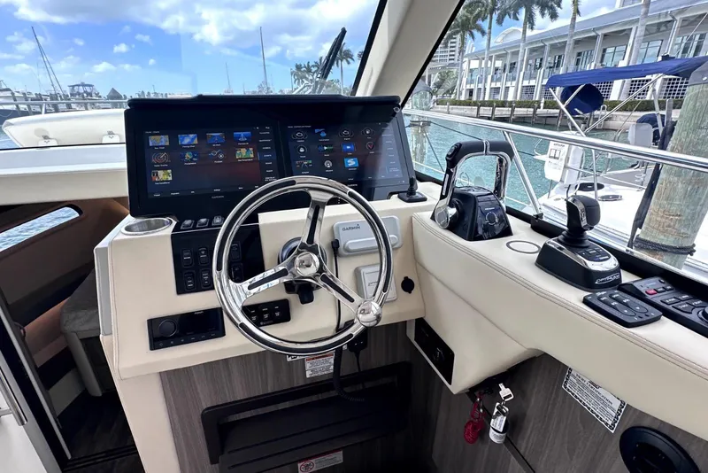 Slide: The Image of 2021 Regal 38 XO yacht helm with advanced navigation controls and touchscreen display. - 29