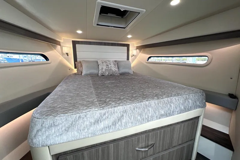 Slide: The Image of Luxurious bedroom interior of 2021 Regal 38 XO yacht with modern design and cozy bedding. - 32