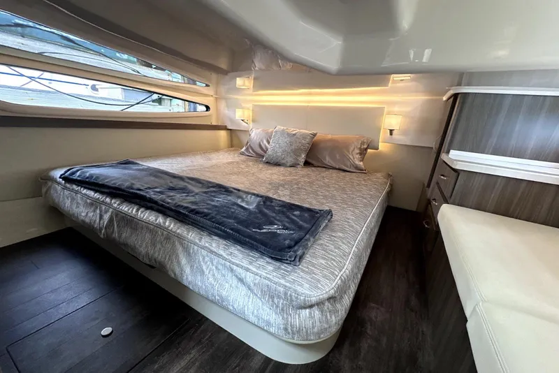 Slide: The Image of Luxurious cabin interior of 2021 Regal 38 XO yacht with cozy bed and modern design. - 38