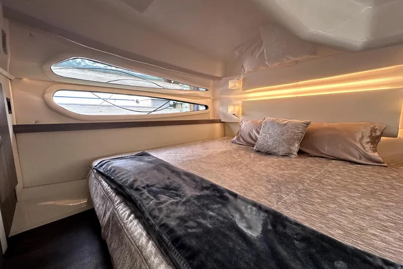 Slide: The Image of Luxurious interior cabin of 2021 Regal 38 XO yacht with elegant bedding and ambient lighting. - 40