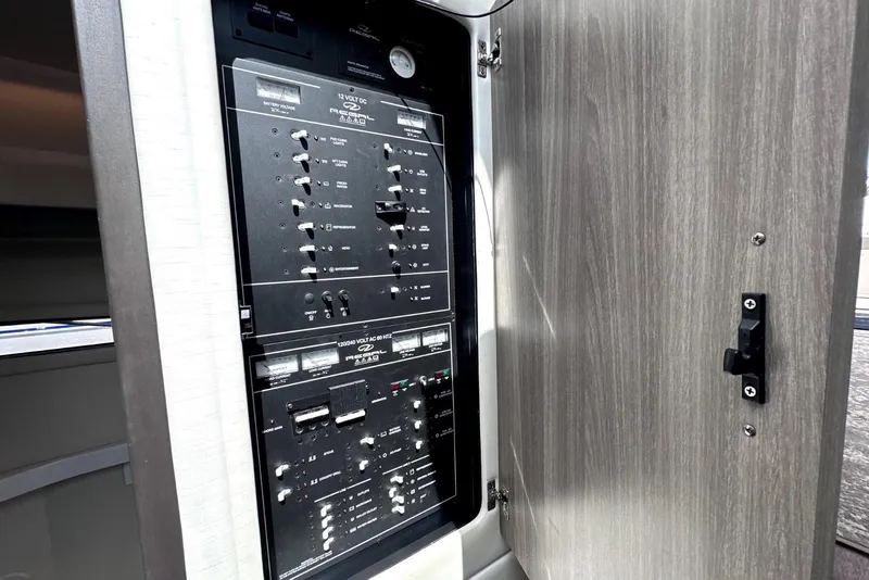 Slide: The Image of Electrical control panel inside 2021 Regal 38 XO yacht, featuring switches and indicators. - 41
