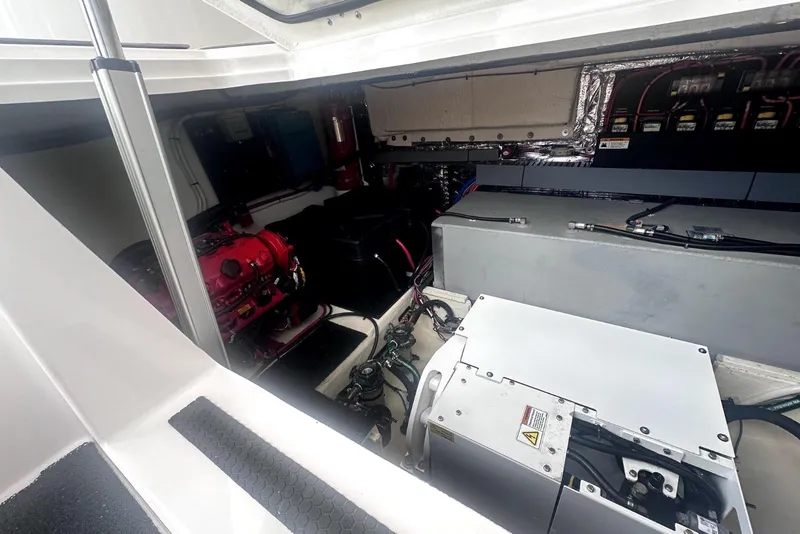 Slide: The Image of Engine compartment of 2021 Regal 38 XO boat, showcasing mechanical components and wiring. - 46