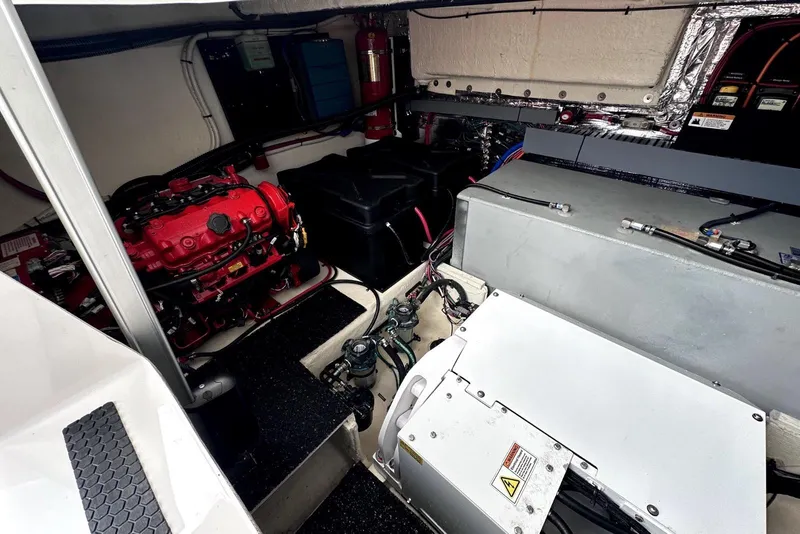 Slide: The Image of Engine room of 2021 Regal 38 XO boat, featuring red engine and various components. - 47