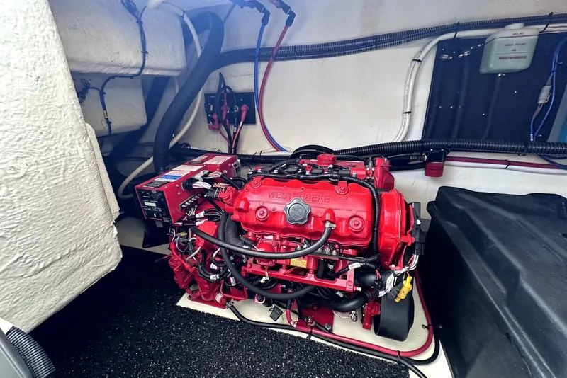 Slide: The Image of Engine compartment of 2021 Regal 38 XO boat with red Westerbeke generator. - 48