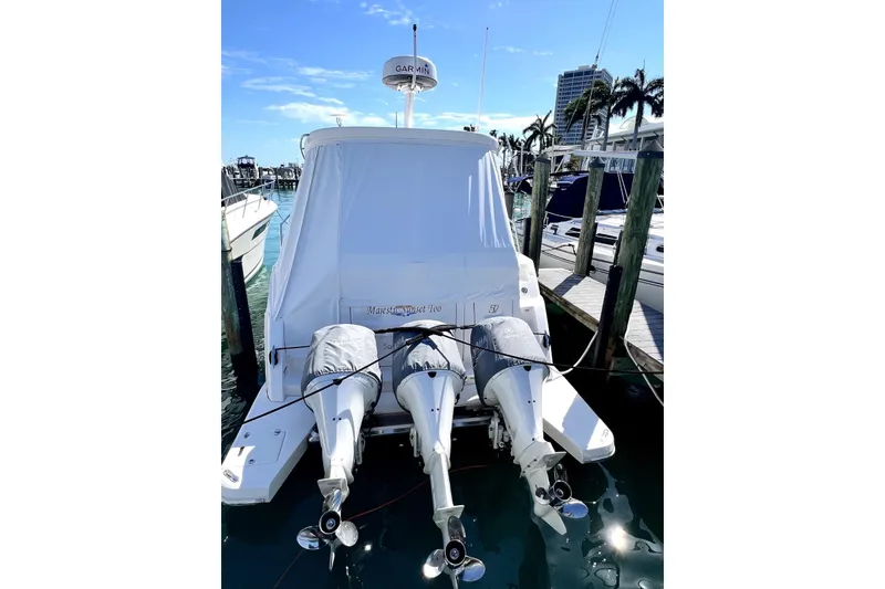 Slide: The Image of 2021 Regal 38 XO yacht docked with twin outboard engines, sunny marina setting. - 5