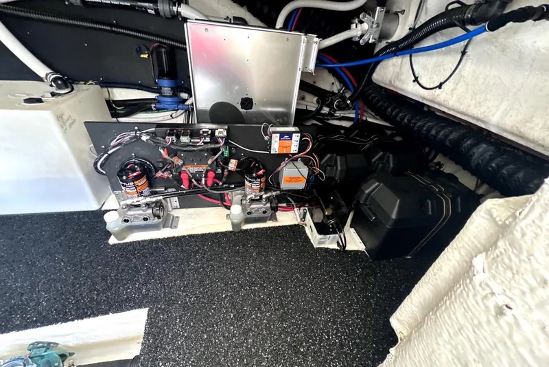 Slide: The Image of Engine compartment of a 2021 Regal 38 XO boat, showcasing electrical components and wiring. - 51