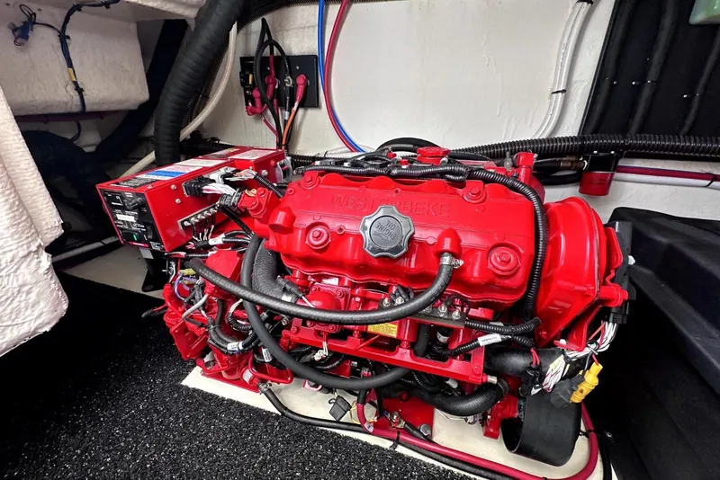 Slide: The Image of Engine compartment of a 2021 Regal 38 XO boat with red engine components. - 53