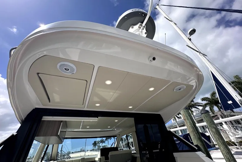 Slide: The Image of 2021 Regal 38 XO yacht exterior with sleek design and modern lighting. - 9