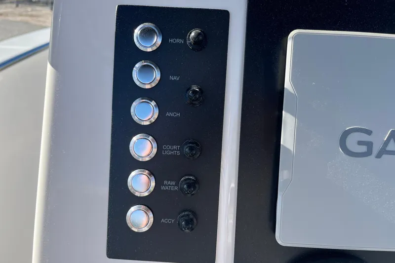 Slide: The Image of Control panel of 2026 Robalo R200 Center Console boat with labeled buttons. - 13