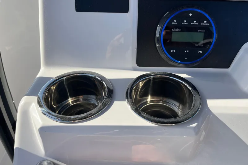 Slide: The Image of Cup holders and audio controls on 2026 Robalo R200 Center Console boat. - 15