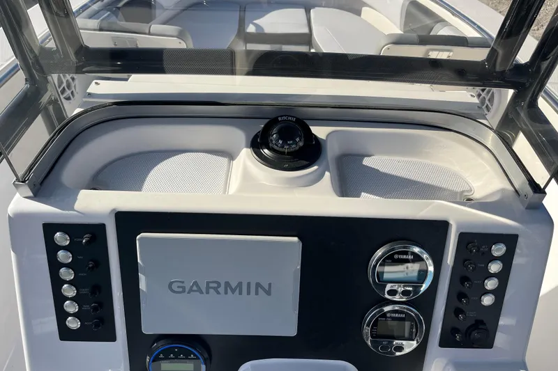 Slide: The Image of 2026 Robalo R200 Center Console dashboard with Garmin navigation and Yamaha controls. - 16