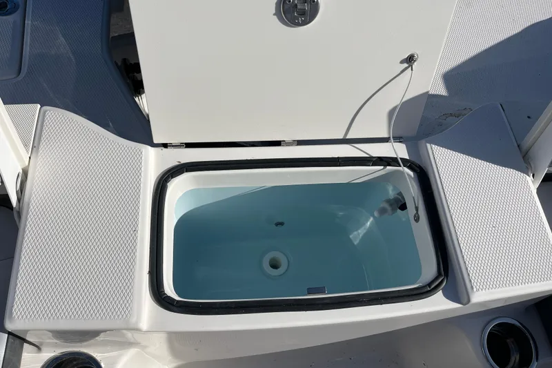 Slide: The Image of Livewell compartment on 2026 Robalo R200 Center Console boat, open and empty. - 20