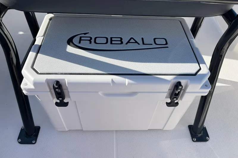 Slide: The Image of 2026 Robalo R200 Center Console cooler under seat, featuring secure latches. - 21