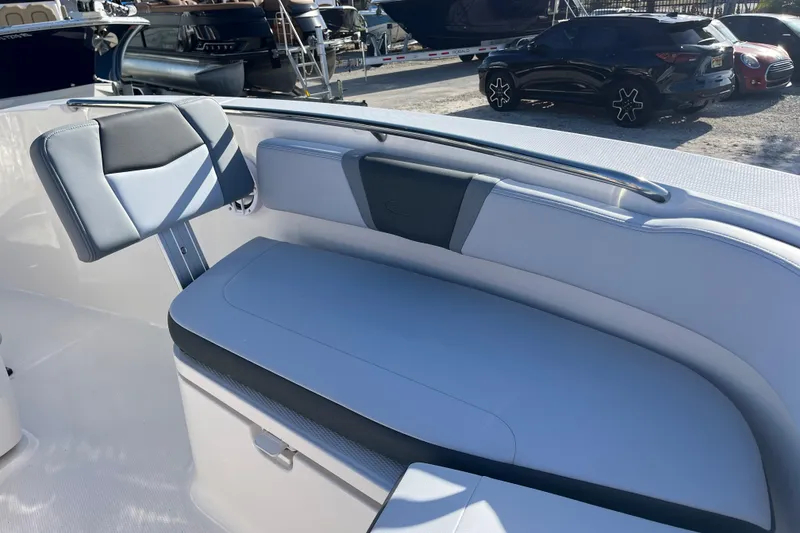 Slide: The Image of 2026 Robalo R200 Center Console boat interior with cushioned seating and storage. - 25