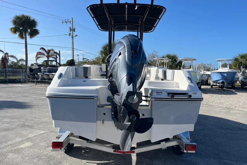 Slide: The Image of 2026 Robalo R200 Center Console boat with outboard motor, parked on a trailer. - 3