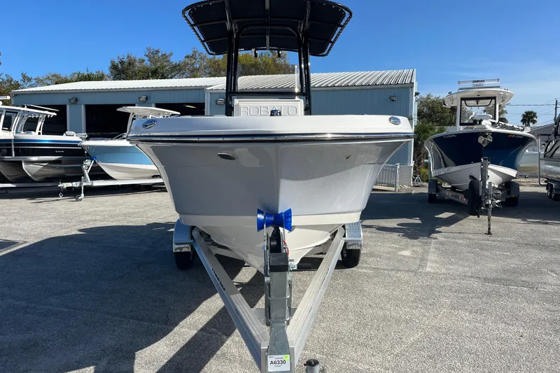 Slide: The Image of 2026 Robalo R200 Center Console boat on trailer, parked outdoors. - 7