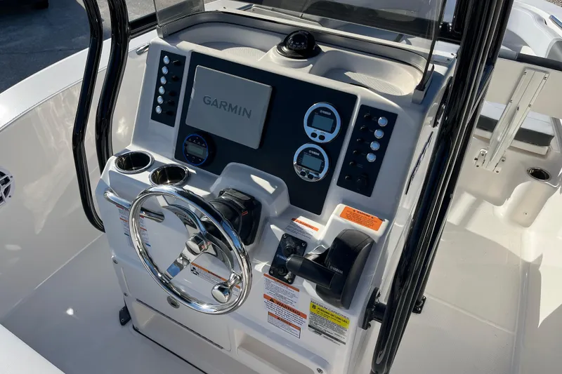 Slide: The Image of 2026 Robalo R200 Center Console boat dashboard with Garmin navigation system. - 9