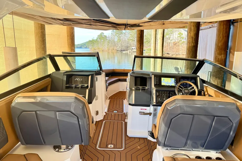 Slide: The Image of Interior of 2025 Cobalt R33 boat with modern dashboard and lake view. - 12