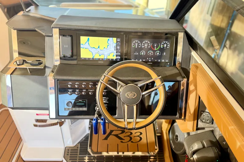 Slide: The Image of Modern Cobalt R33 boat dashboard with steering wheel and digital displays, 2025 model. - 15